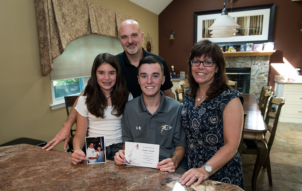 Feature story about children born on 9/11. Daniel and Tricia Shay's son, Danny Shay, was born on 9/11/01. They live in Holtsville, Aug. 30, 2018.L-R Emma Shay holds a baby picture of Danny, father Daniel Shay, Danny Shay, with his birth announcement and mother Tricia Shay.